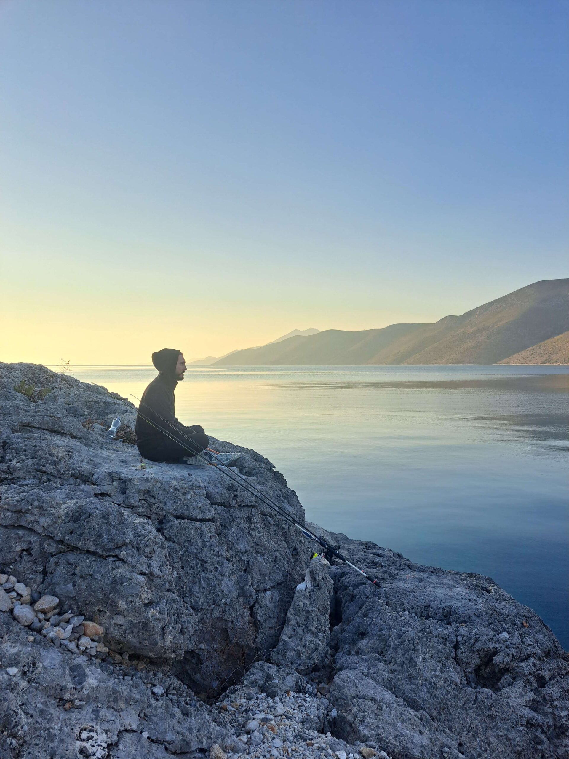 Kai sitting by the ocean and looking at it